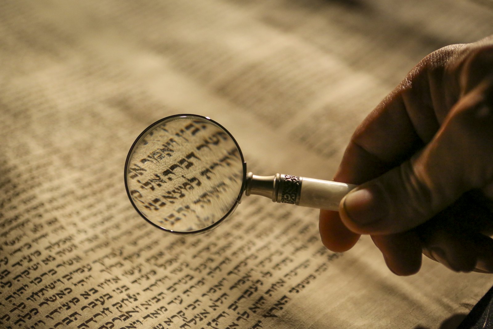 Person holding a magnifying glass