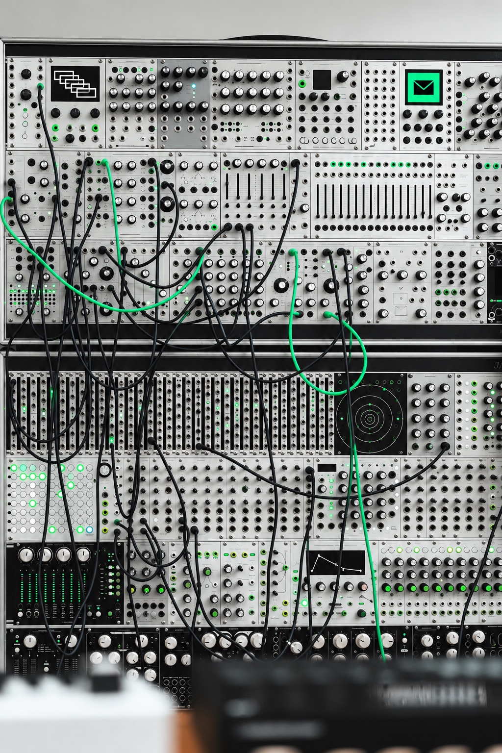 White modular rack wired with black and mint cables